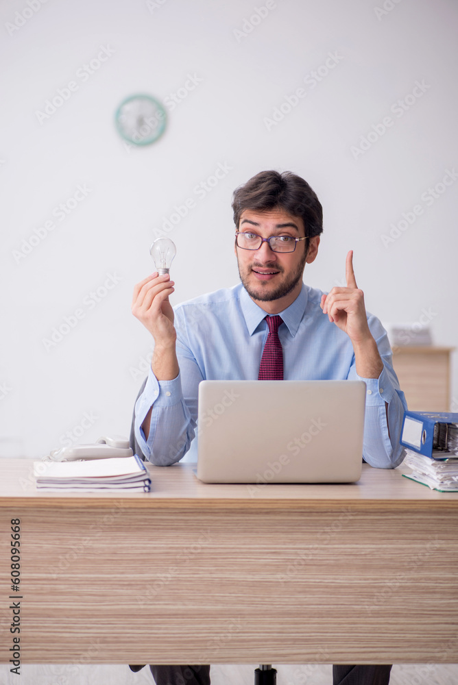 Young male employee in brainstorming concept Young male employee in brainstorming concept