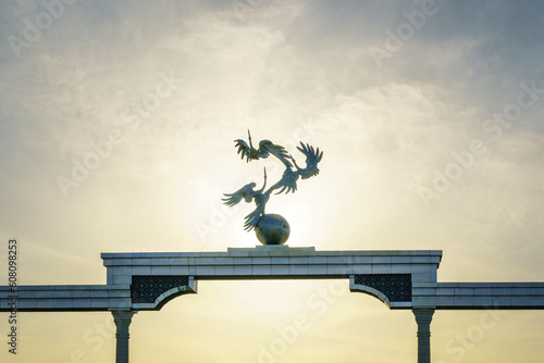 Independence Memorial at Independence Square in Tashkent illuminated at sunset. photo