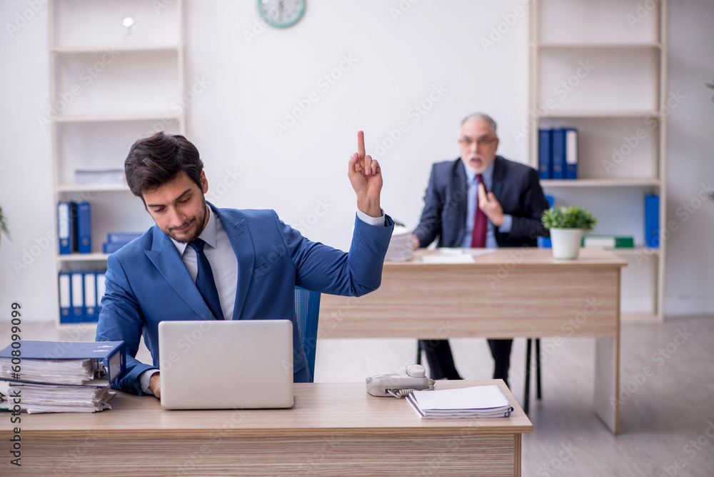 Two male colleagues working in the office Two male colleagues working in the office