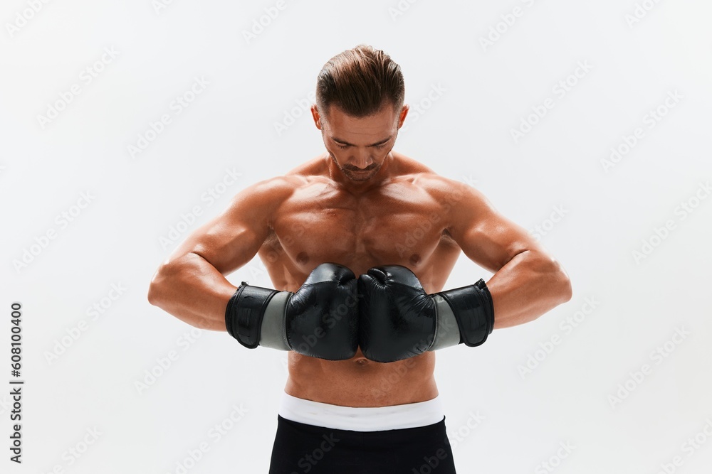 Man athletic bodybuilder poses in boxing gloves with nude torso abs in full-length background, boxing and martial arts. Advertising, sports, active lifestyle, competition, challenge concept. Man athletic bodybuilder poses in boxing gloves with nude torso abs in full-length background, boxing and martial arts. Advertising, sports, active lifestyle, competition, challenge concept.