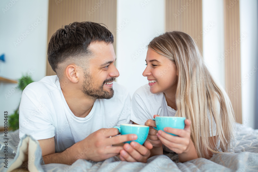 Young married couple in love having coffee in their bed. Good morning! Healthy breakfast in bed. Young beautiful love couple is having coffee in bed.