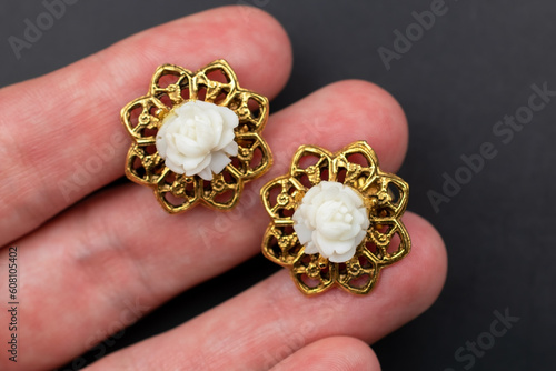 Vintage flower earrings close up, retro jewelry concept, promotional photo for an online jewelry store