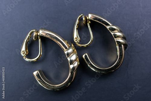 Gold vintage earrings close up, retro jewelry concept, promotional photo for an online jewelry store
