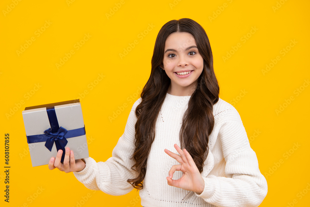 Child with gift present box on isolated background. Presents for birthday, Valentines day, New Year or Christmas. Happy face, positive and smiling emotions of teenager girl. Child with gift present box on isolated background. Presents for birthday, Valentines day, New Year or Christmas. Happy face, positive and smiling emotions of teenager girl.