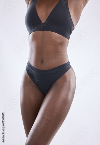 Body, fitness and health with woman in studio for nutrition, weight loss and stomach diet. Beauty, wellness and abdomen muscle with closeup of female model on white background for self care and glow