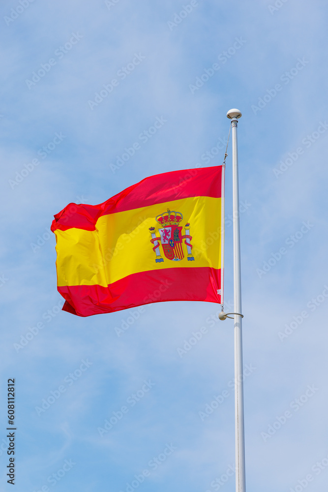 Spain flag waving in the wind on blue sky Spain flag waving in the wind on blue sky