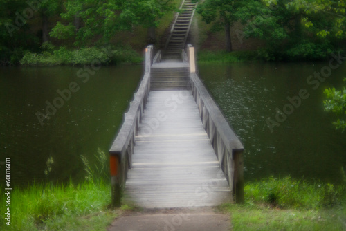 Footbridge across the water with stairway soft focus for mystery, dream or adventure