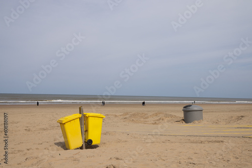 Dumpsters on a deserted sandy seashore