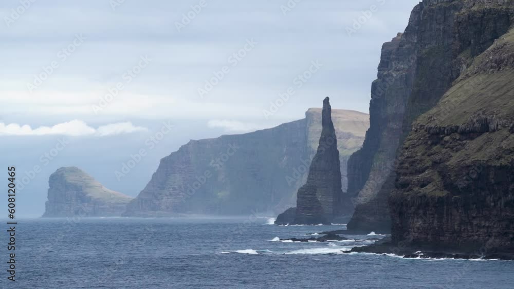 Waves Onto Rock Cliffs In Oknadalsdrangur, Sandoy, Faroe Islands, Denmark. Timelapse Waves Onto Rock Cliffs In Oknadalsdrangur, Sandoy, Faroe Islands, Denmark. Timelapse