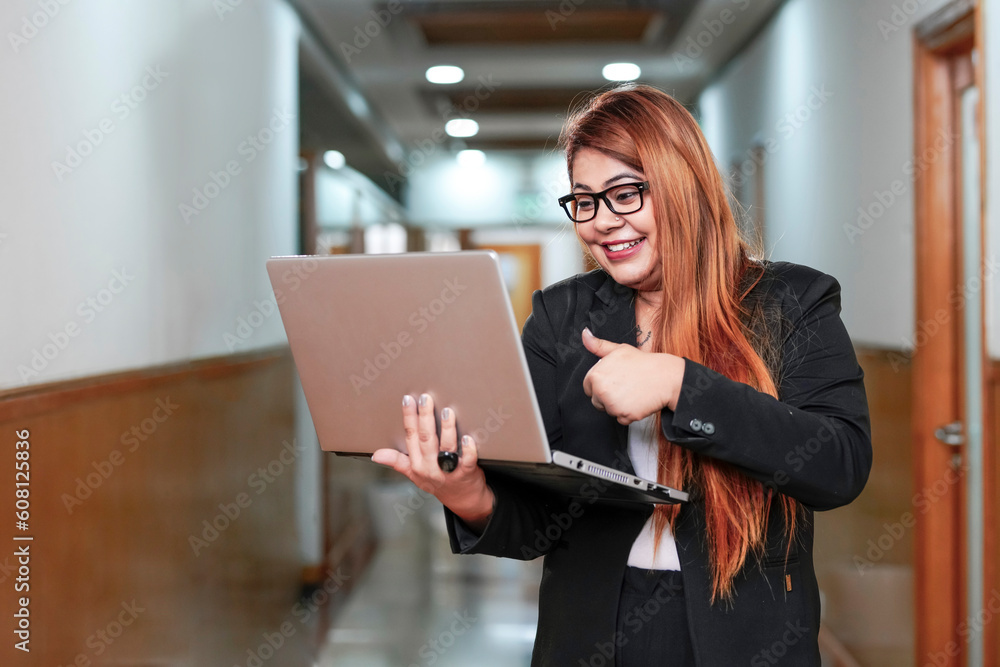 Young indian corporate woman using laptop. Young indian corporate woman using laptop.