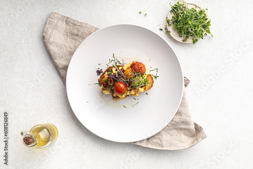 Fototapeta Naklejka Na Ścianę i Meble -  Gourmet breakfast bruschetta with scrambled egg and vegetables