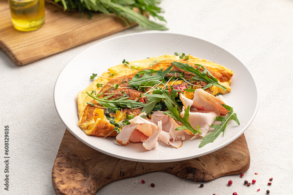 Portion ofgourmet omelette breakfast with smoked chicken Portion ofgourmet omelette breakfast with smoked chicken