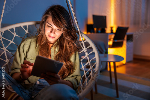 Woman relaxing at home reading an ebook