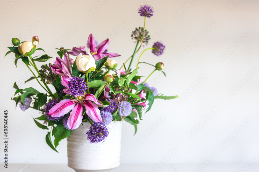 Flowers from a home garden in a vase on a white background.