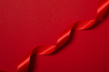 Concept of different ribbons, red ribbon on red background