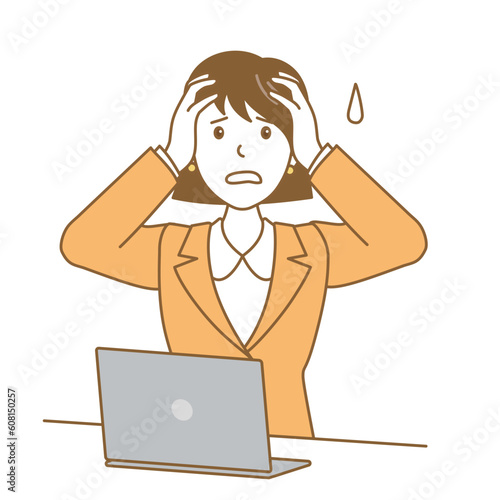 パソコンの前で頭を抱えるスーツ女性