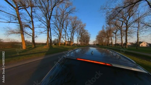 Slow Motion Rotating Shot of A Car Driving Past A Flying Stork. photo