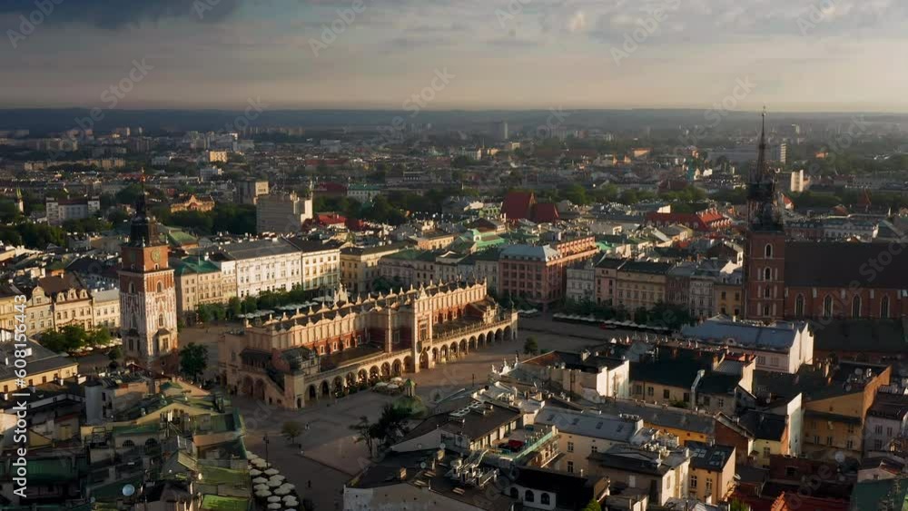 Panorama of Main Square (Saint Mary's Basilica, Sukiennice - Town Hall, Town Hall Tower) in Krakow, Poland during magic stormy weather with soft morning light. Panorama of Main Square (Saint Mary's Basilica, Sukiennice - Town Hall, Town Hall Tower) in Krakow, Poland during magic stormy weather with soft morning light.