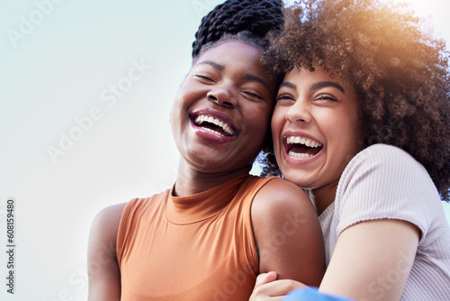 Fototapeta Couple of friends, black women and hug outdoor while laughing with freedom, happiness and lgbtq love