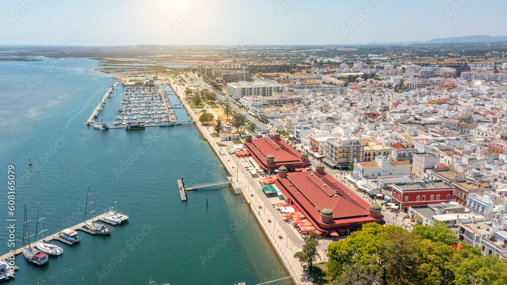 Aerial view of Portuguese fishing tourist town of Olhao with a view the Ria Formosa Marine Park. Sea port for yachts on a sunny day, 