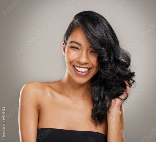 Haircare  beauty and portrait of happy woman in studio for cosmetics  treatment and shine on grey background. Hair  face and satisfied female model posing with volume  texture and keratin results