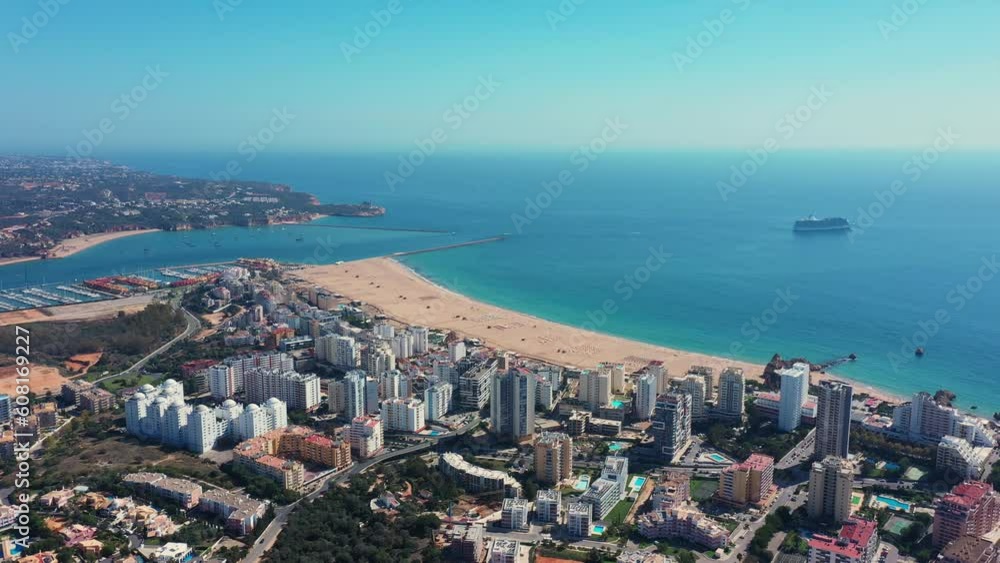 Tourist Portuguese city of Portimao aerial view on a sunny day. South Portugal Algarve. bay in the background and liner Tourist Portuguese city of Portimao aerial view on a sunny day. South Portugal Algarve. bay in the background and liner