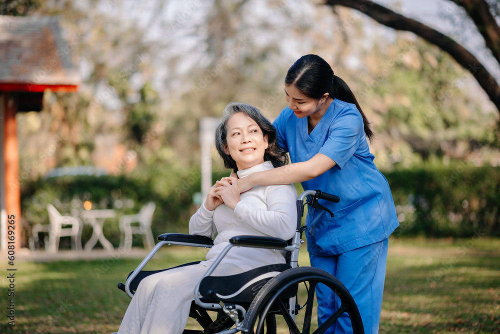Elderly asian senior woman on wheelchair with Asian careful caregiver. Elderly asian senior woman on wheelchair with Asian careful caregiver.
