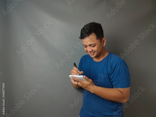 Young asian man shocked when he looking and pointing smartphone