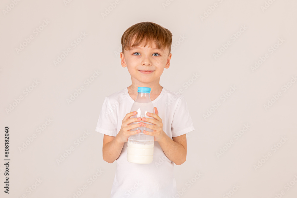 Cute kid holding plastic bottle of milk on white background. advertisement. High Quality Cute kid holding plastic bottle of milk on white background. advertisement. High Quality