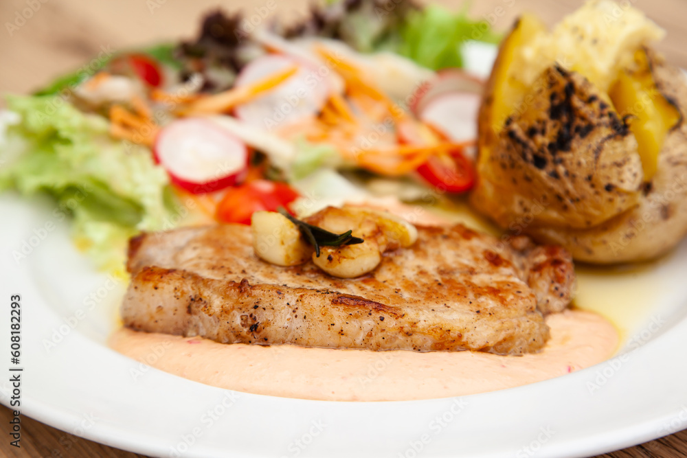 Pork sirloin steak with baked potato and andalouse sauce Pork sirloin steak with baked potato and andalouse sauce