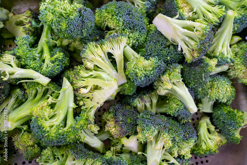 Broccoli florets in a pile, ready for cooking. Brocolli plant is in the cabbage family.