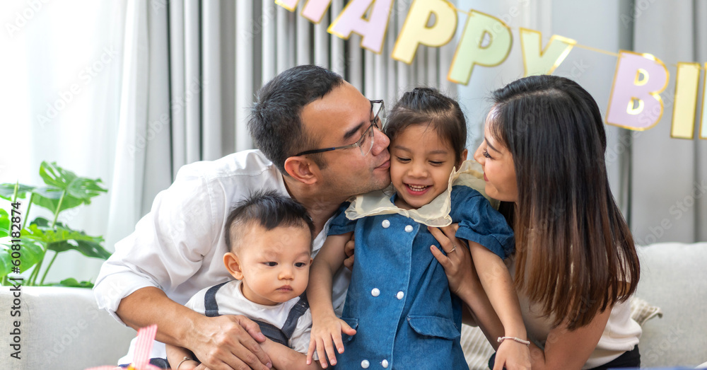 Portrait of enjoy happy love asian family father and mother holding hug cute little asian girl child smiling play and having fun moments good time in at home Portrait of enjoy happy love asian family father and mother holding hug cute little asian girl child smiling play and having fun moments good time in at home