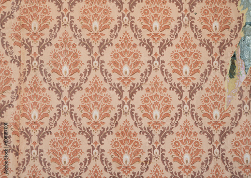 Old torn wallpaper on the wall.Old wallpaper for texture or background.