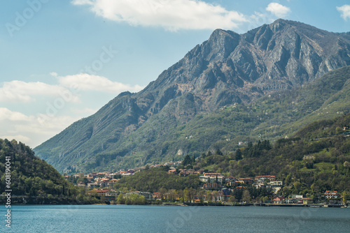 Lake Como from the shore of the city of Lecco. View of the Alps mountains, buildings and the town of Malgrate. 