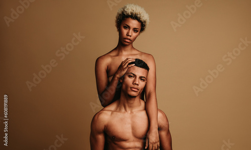 Young couple showing body confidence in monochrome portrait