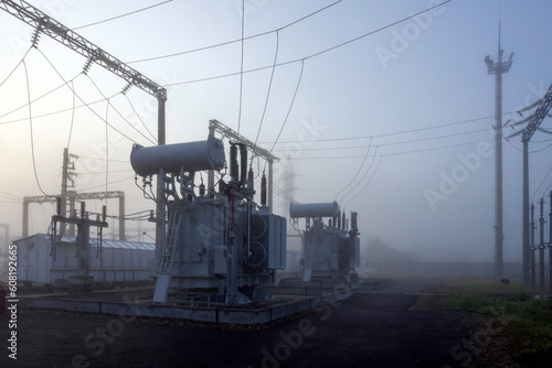 Voltage transformer substation on a foggy spring morning. Transformer in the fog.