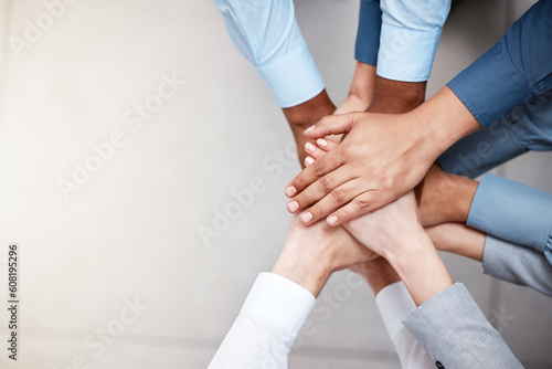 Hands, mockup and business people in a huddle from above for support, motivation or solidarity. Collaboration, teamwork and space with a group of colleagues or employees standing in a circle at work