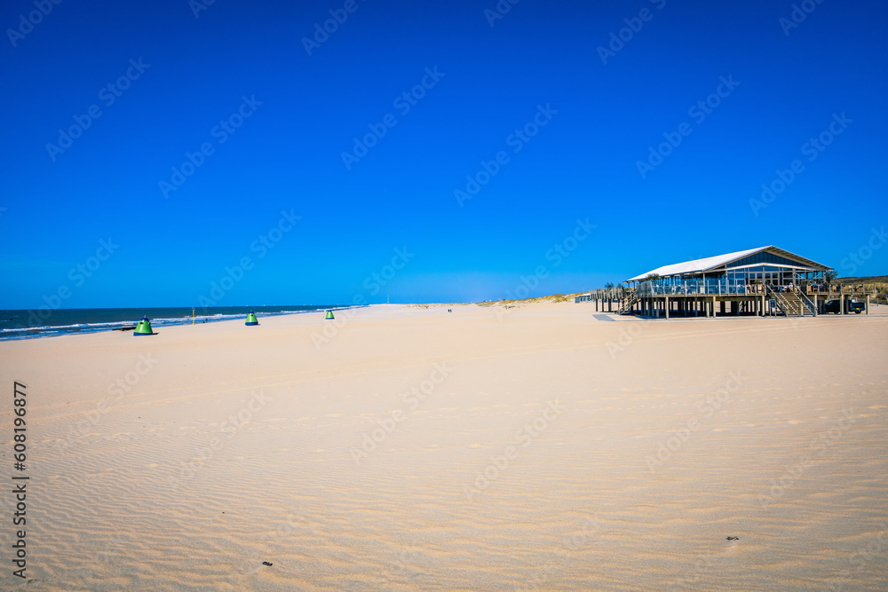 A Cafe in the Foreground of a Sunny Day at the Yellow Sand Beach near The Hague