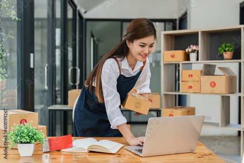 Business From Home Asian woman preparing package delivery box Shipping for shopping online. young start up small business owner at home online order