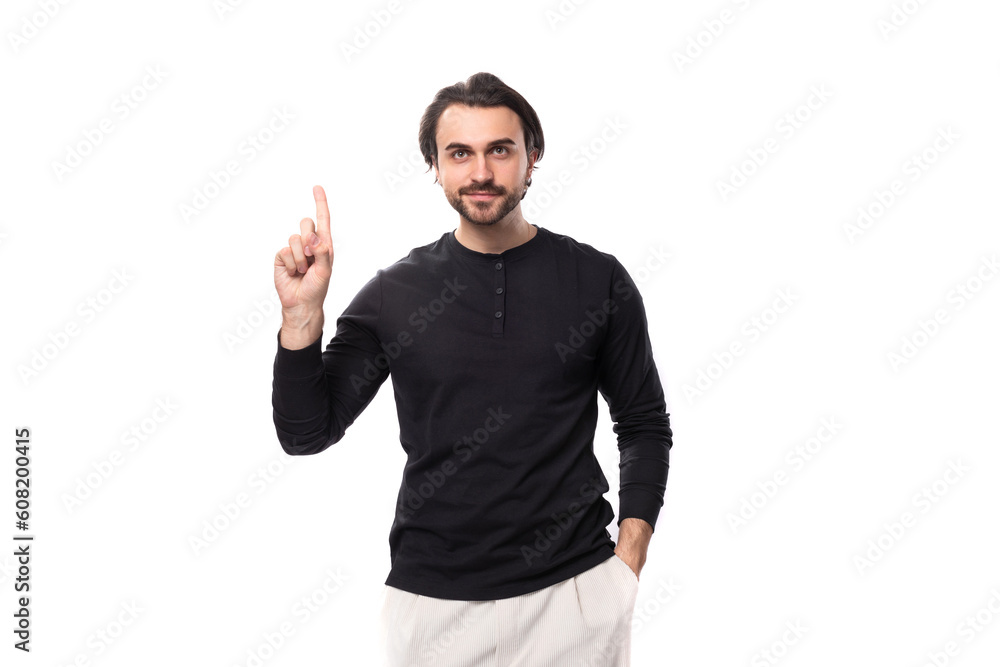 young handsome brunet european man in a black sweatshirt enthusiastically communicates an idea on an isolated white background young handsome brunet european man in a black sweatshirt enthusiastically communicates an idea on an isolated white background