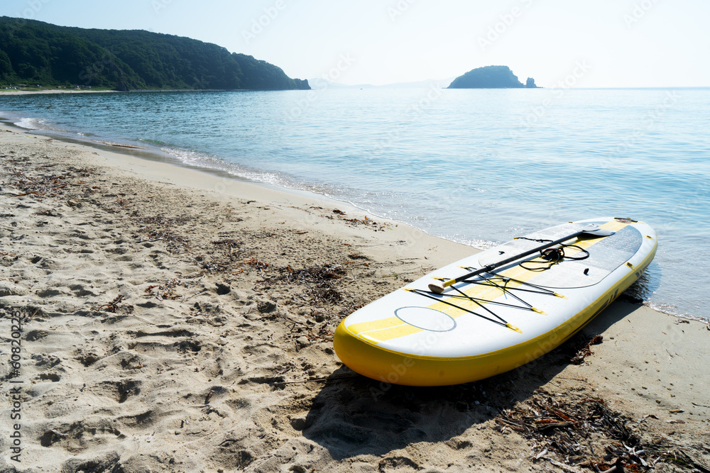 Empty seaside landscape sea sand beach with supboard on coast calm wave water surface Empty seaside landscape sea sand beach with supboard on coast calm wave water surface
