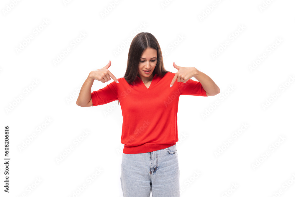 young inspired caucasian brunette woman in a red short sleeve shirt points with her hands to the sides young inspired caucasian brunette woman in a red short sleeve shirt points with her hands to the sides