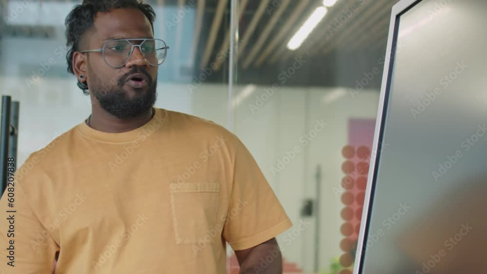 PAN shot of man giving business presentation to multi-ethnic gen Z coworkers on office meeting PAN shot of man giving business presentation to multi-ethnic gen Z coworkers on office meeting
