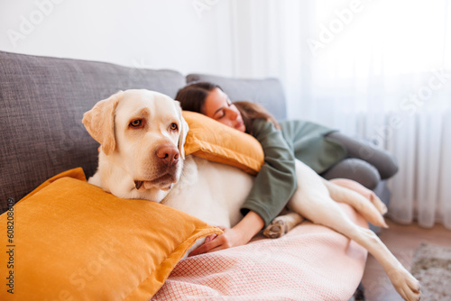 Female pet owner and her dog taking an afternoon nap