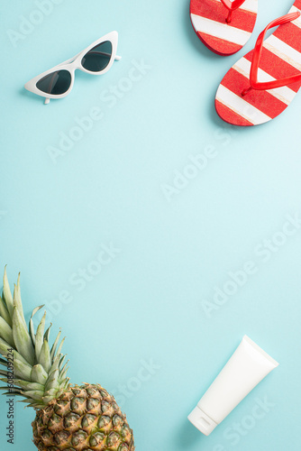 Indulge in the spirit of summer with stunning top vertical view flat lay. Uncover a pineapple, flip-flops, sunglasses, cream on a pastel blue backdrop with blank space for promotion
