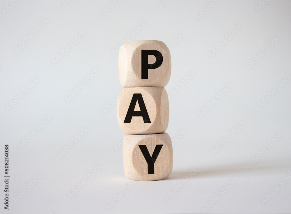 Payment symbol. Wooden cubes with words Pay. Beautiful white background. Business and Pay concept. Copy space. Payment symbol. Wooden cubes with words Pay. Beautiful white background. Business and Pay concept. Copy space.