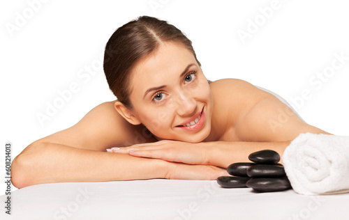 Relaxed young female getting a stone massage in a spa salon
