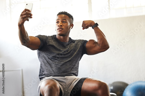 Selfie, muscle flex and man for gym, fitness and workout results, progress and social media update of body goals. Bodybuilder or african person with profile picture, photography and exercise in power