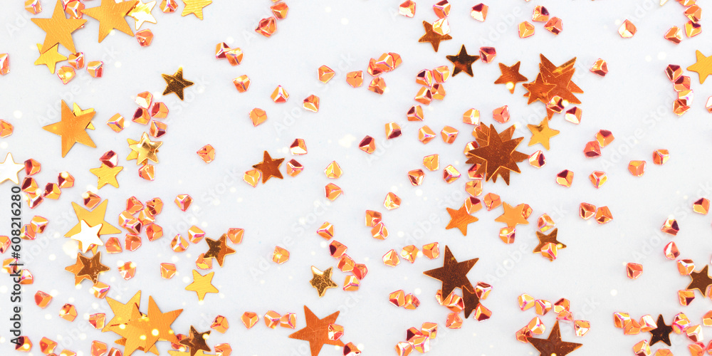 Banner with shiny golden stars and crystals confetti on a blue background. Selective focus. Banner with shiny golden stars and crystals confetti on a blue background. Selective focus.