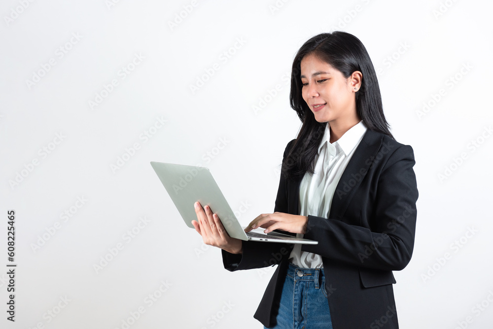 Beautiful asian business woman in suit standing and using laptop computer for work, Smart female wearing business suit standing against white background. Beautiful asian business woman in suit standing and using laptop computer for work, Smart female wearing business suit standing against white background.
